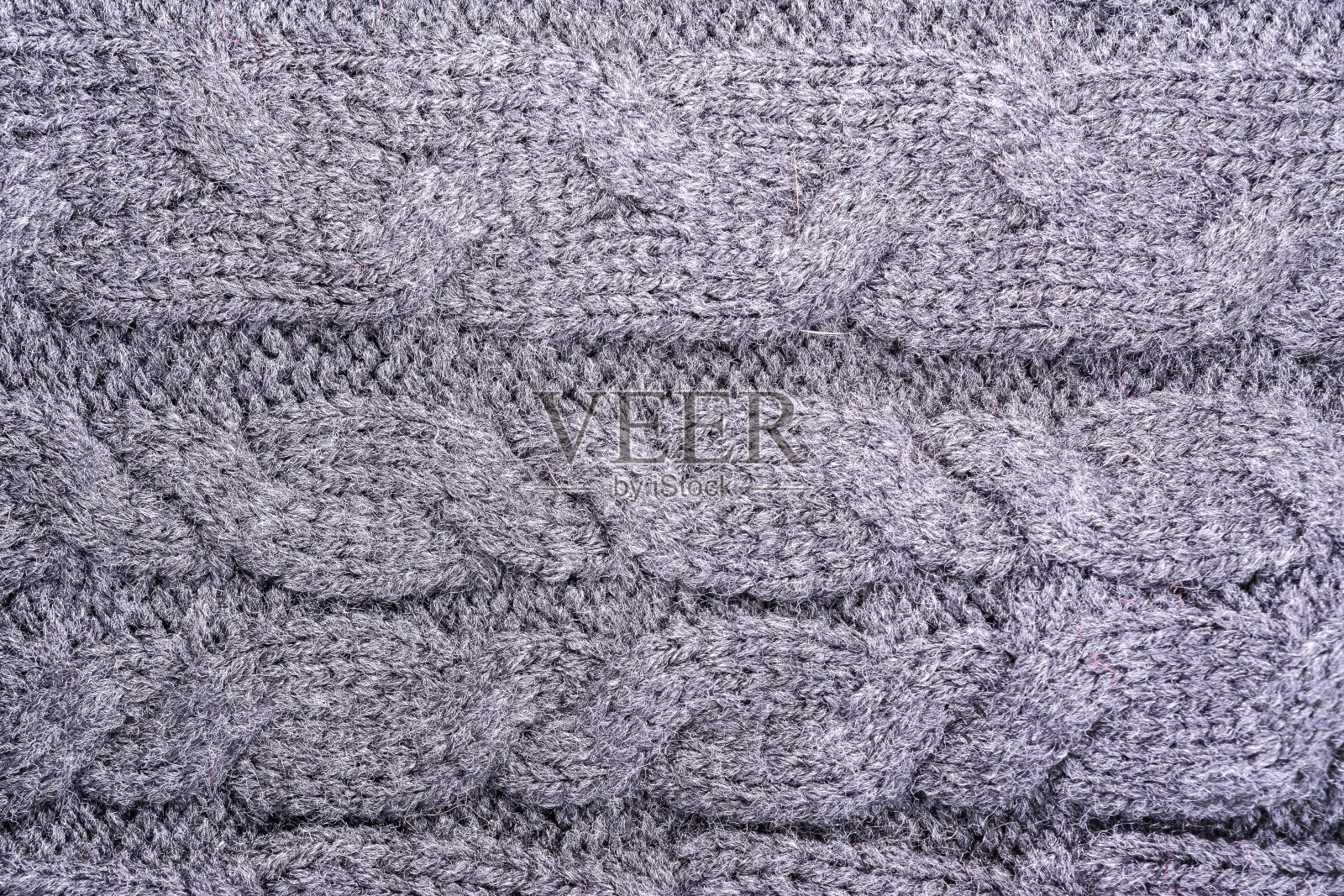 一種帶有辮子圖案、抽象背景的針織毛織品表面的紋理照片攝影
